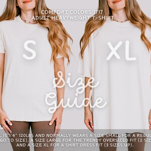 May include: A size guide for a white t-shirt, showing a model wearing sizes S and XL. The model is 5'4" and 120 lbs. The text reads "COMFORT COLORS 1717 ADULT HEAVYWEIGHT T-SHIRT" and "Size Guide".
