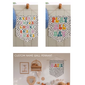 May include: Three wall pennants with a black and white polka dot background. The first pennant features the alphabet in colourful letters. The second pennant says "Play All Day" in colourful letters. The third pennant says "Katie" in colourful letters.