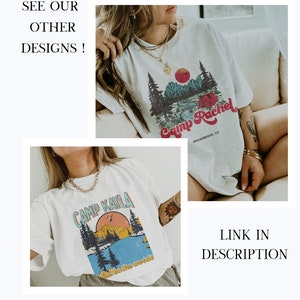 May include: Two white t-shirts with a camping theme. The first shirt has the text "Camp Kayla" and a graphic of a mountain, lake, and trees. The second shirt has the text "Camp Rachel" and a graphic of a lake, trees, and a tent. Both shirts have a distressed look.
