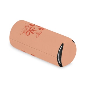 May include: A peach-colored neoprene can cooler with a red illustration of a martini glass with an olive and a red bow. The text "A little bit of" is printed above the glass and the text "class" is printed below the glass.