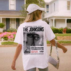 May include: White t-shirt with a black and white graphic print of a wedding tour poster for "The Johnsons, David & Anna". The poster features the text "Wedding Tour 2025", "Park City 24 May", "Live from Sound House", "Featuring Amanda Flynn as Maid of Honor", "Tyler Morgan as Best Man", "One Night Only", and "Sold Out".