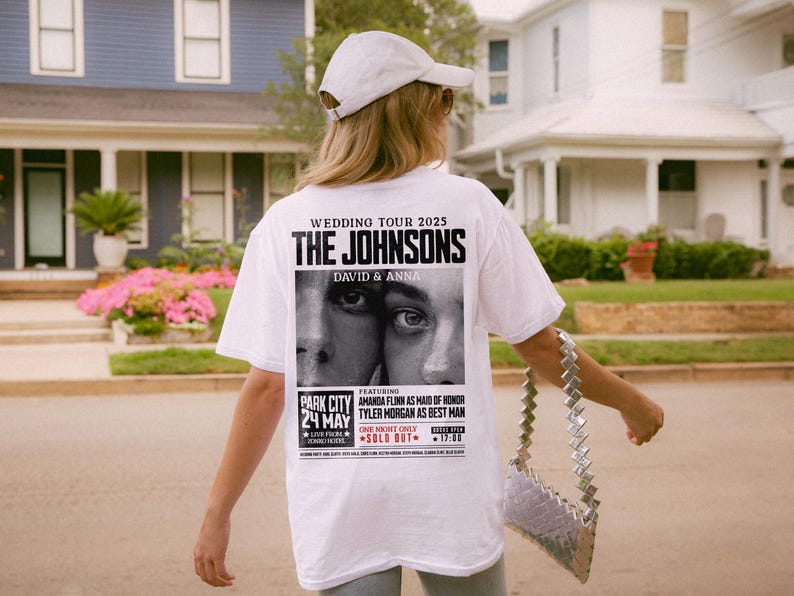 May include: White t-shirt with a black and white graphic print of a wedding tour poster for "The Johnsons, David & Anna". The poster features the text "Wedding Tour 2025", "Park City 24 May", "Live from Sound House", "Featuring Amanda Flynn as Maid of Honor", "Tyler Morgan as Best Man", "One Night Only", and "Sold Out".