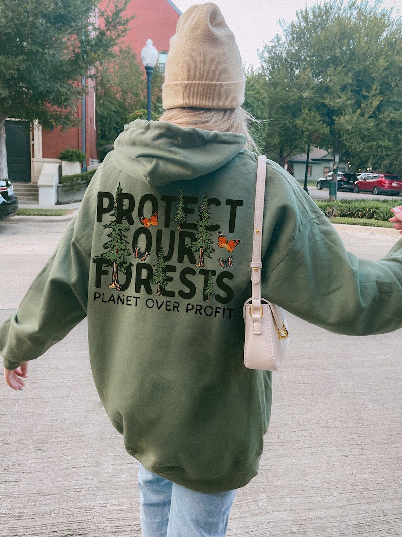 May include: A green hooded sweatshirt with the text "PROTECT OUR FORESTS PLANET OVER PROFIT" printed on the back. The text is surrounded by a graphic of trees and butterflies.