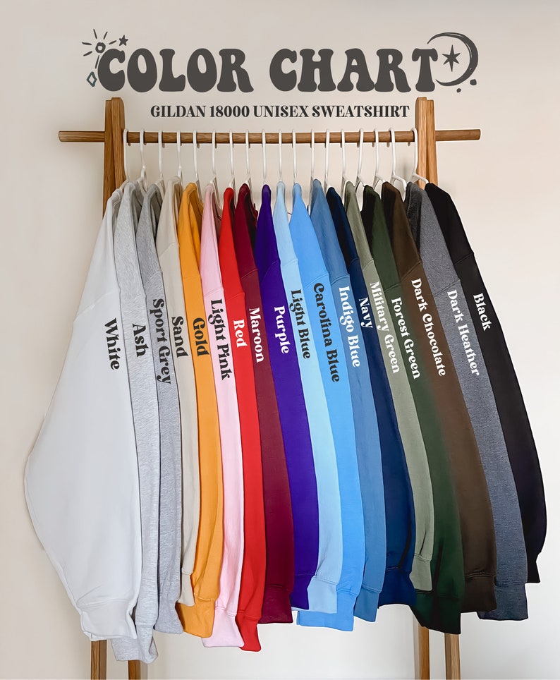 May include: A color chart of Gildan 18000 unisex sweatshirts. The chart shows 16 different colors, including white, ash, sport grey, sand, gold, light pink, red, maroon, purple, light blue, carolina blue, indigo blue, navy, military green, forest green, dark chocolate, dark heather, and black.