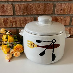 West Bend 1960s stoneware bean pot with utensil decoration