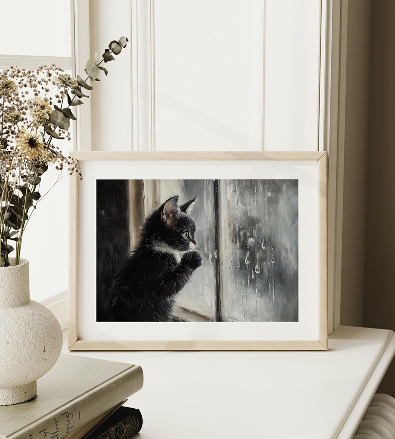 Cute kitten looking at rain through a window.