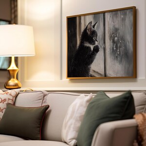 Tuxedo kitten staring at raindrops with a soft glow.