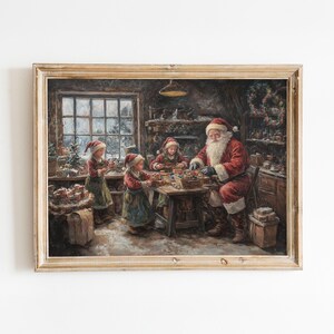 Op de afbeelding: Een schilderij van Sinterklaas met twee kinderen in een werkplaats. Sinterklaas draagt een rood pak en een witte baard. De kinderen dragen rode en witte mutsen en helpen Sinterklaas met zijn werk. De werkplaats is versierd met kerstversiering.