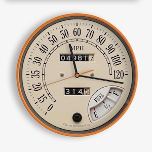 May include: A round speedometer wall clock with an orange outer rim and a cream-coloured face. The dial features black numbers from 0 to 120 MPH, a digital odometer reading 049817, a secondary display reading 3145, and a fuel gauge labelled E to F.