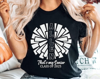 May include: Black t-shirt with a white cheerleader pom-pom design. The word "ALLEN" is centered within the pom-pom, with the text "That's my Senior CLASS OF 2025" below. The shirt is a classic crew neck.