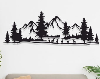 May include: Black metal wall art depicting a mountain range with trees and deer. The art is mounted on a white wall above a gray couch and a glass coffee table.