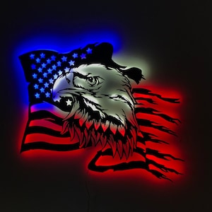 May include: A red, white, and blue American flag with an eagle's head in the center. The flag is lit up with red, white, and blue lights.