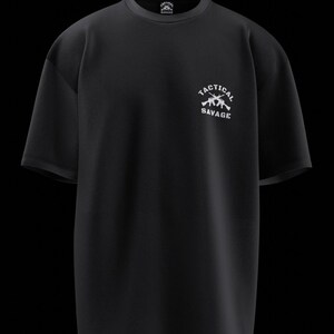 May include: Black t-shirt with the text "TACTICAL SAVAGE" in white, along with a graphic of two rifles. The shirt has a crew neck and short sleeves. The design is centered on the chest.