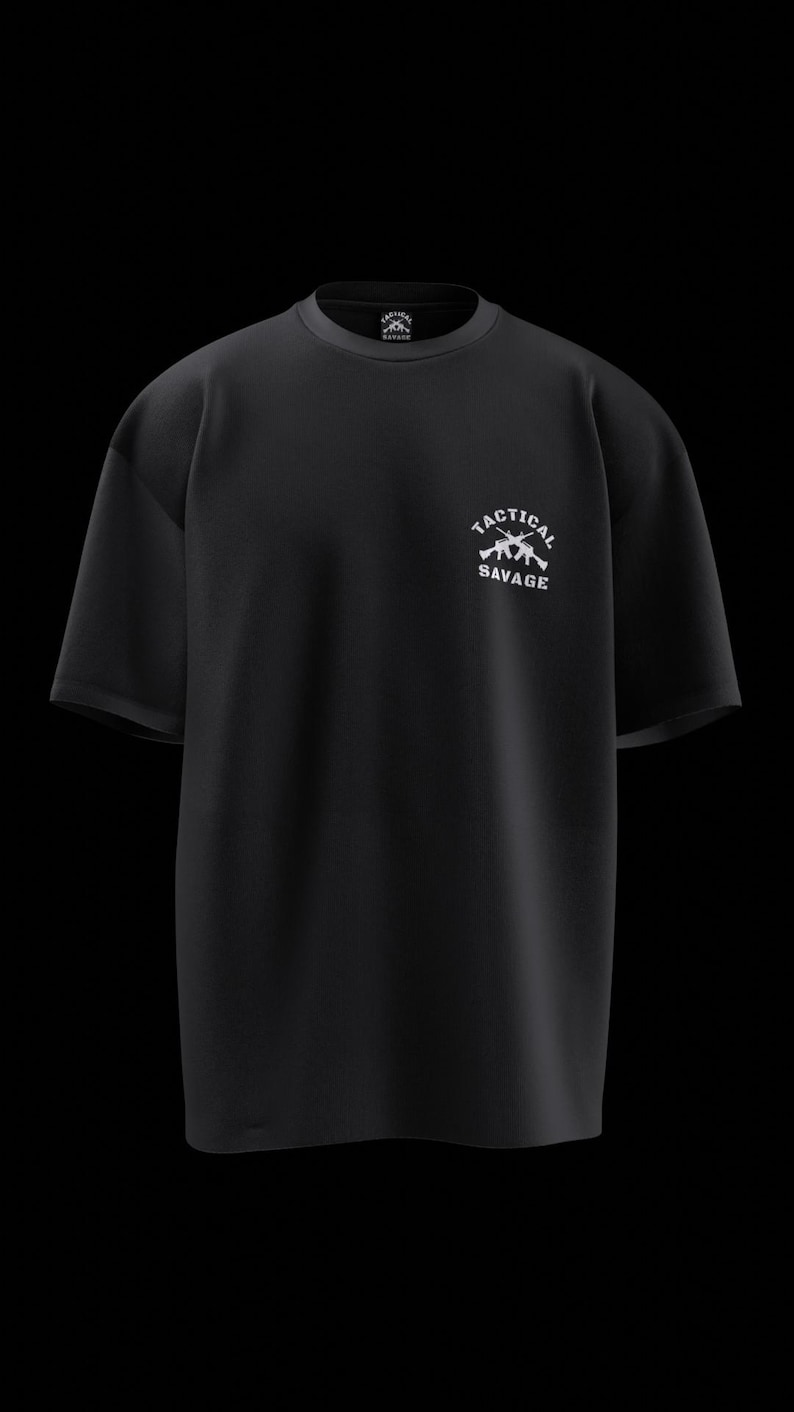 May include: Black t-shirt with the text "TACTICAL SAVAGE" in white, along with a graphic of two rifles. The shirt has a crew neck and short sleeves. The design is centered on the chest.
