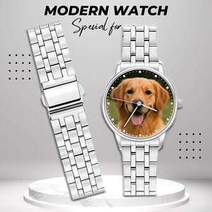 May include: A silver-toned wristwatch with a stainless steel band and a watch face featuring a golden retriever. The watch face is surrounded by small, silver-colored dots. The text "MODERN WATCH" and "Special for" are at the top.