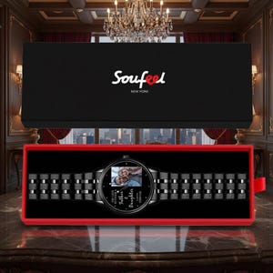 May include: A black wristwatch with a photo on the face, presented in a black box with a red interior. The watch band is black and metallic. The watch face has the words "Father & Daughter Forever" and the brand name "Soufeel" is on the box.
