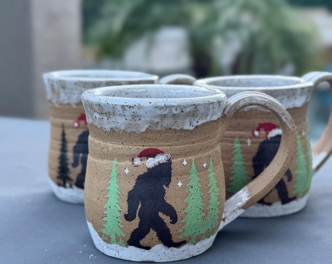 Featured listing image: Handmade Ceramic Mug | Matte Forest Bigfoot with Santa Hat | Speckled Buff Clay | 16 oz Wheel-Thrown Pottery Cup