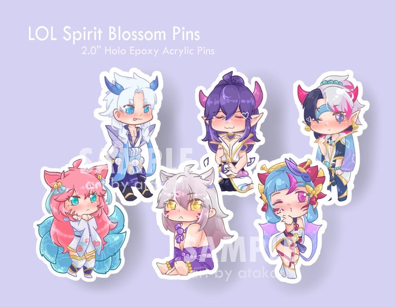 May include: Six 2.0 inch holographic epoxy acrylic pins featuring characters from the video game League of Legends. The characters are depicted in a chibi style with colorful outfits and accessories. The pins are designed with a white border and a glossy finish.