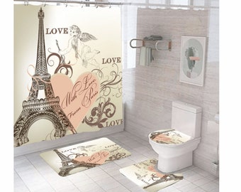 May include: A bathroom shower curtain, toilet seat cover, and bath mat set with a Parisian theme. The shower curtain features a black and white illustration of the Eiffel Tower with a pink heart that says "With Love from Paris". The toilet seat cover and bath mat have the same design.