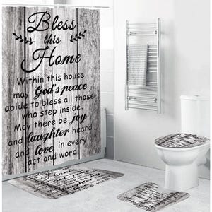 May include: A bathroom set featuring a shower curtain, toilet seat cover, and two rugs. The set has a gray and white wood-grain design with the words "Bless this Home" and a poem printed on it. The set includes a towel rack and a white toilet.