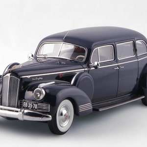 May include: A black 1941 Packard 180 limousine with chrome accents and a license plate that reads "EB 35 78".