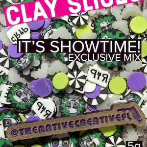 May include: A 5g bag of colorful clay slices featuring a variety of designs, including a cartoon character with green hair and a black and white swirl pattern. The bag is labeled "Clay Slices" and "It's Showtime! Exclusive Mix".