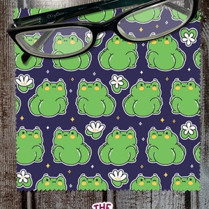 May include: A dark blue microfiber cleaning cloth with a repeating pattern of green frogs and white flowers. The cloth has the text "THE native creative" in pink letters in the bottom right corner.