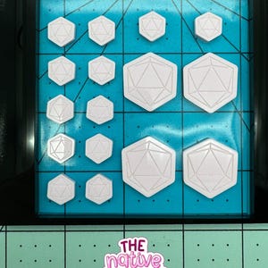 May include: White geometric dice shapes of various sizes are arranged on a blue surface. The dice are set against a teal grid background. The Native Creative logo is visible in the image.
