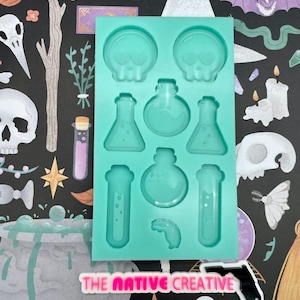 May include: A teal silicone mold with 10 different shapes for resin casting. The shapes include skulls, potion bottles, and test tubes. The mold is labeled "The Native Creative".