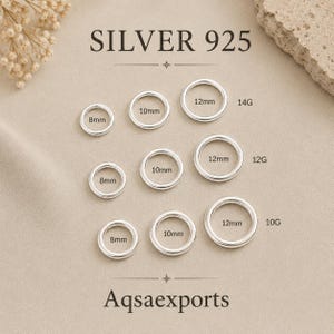 Puede incluir: Una colección de nueve anillos de plata 925 dispuestos en tres filas y tres columnas. Los anillos están etiquetados con diámetros de 8mm, 10mm y 12mm, y calibres de 14G, 12G y 10G. El texto SILVER 925 y Aqsaexports está impreso en la imagen.