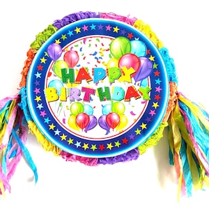 May include: A colorful "Happy Birthday" pinata with a blue background and stars. The pinata is decorated with colorful balloons and confetti. It has rainbow streamers attached.
