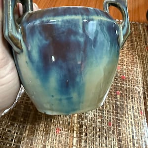 May include: A set of three ceramic mugs with a speckled, matte finish. The mugs are in shades of cream, light gray, and dark gray. Each mug has a simple, minimalist design, perfect for coffee or tea.