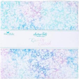 May include: A pack of 10-inch fabric squares featuring a white damask pattern on a blue and purple watercolor background. The fabric squares are part of the "Candy Coated" collection by Riley Blake Designs.