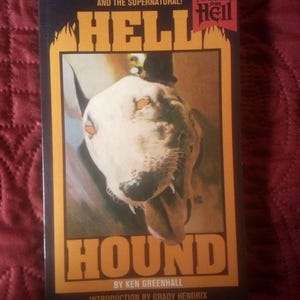 May include: A paperback book titled "Hell Hound" with a dog illustration on the cover. The cover features the text "A Thriller of the Surreal and the Supernatural!" and "Paperbacks from Hell".