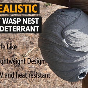 May include: A gray, spherical wasp nest deterrent hanging from a wooden structure. The product is labeled "Realistic Wasp Nest Deterrent" with text indicating it is life-like, lightweight, and UV and heat resistant.