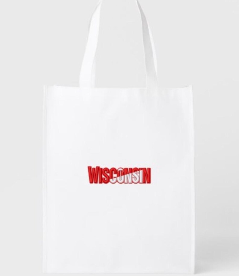 May include: White tote bag with red text that reads "WISCONSIN". The bag has two white handles and is made of a lightweight material. The text is in a bold, 3D style.