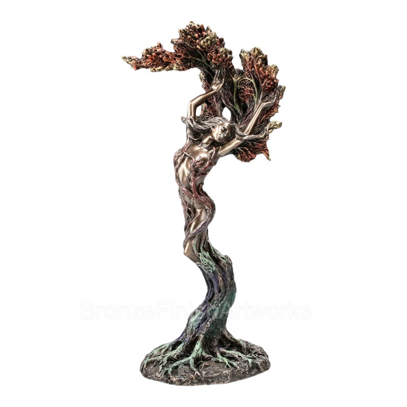 May include: A bronze-toned sculpture depicting a figure merging with a tree, featuring roots at the base, a trunk-like torso, and branches forming a canopy above. The finish includes metallic brown, green, and reddish-copper highlights.
