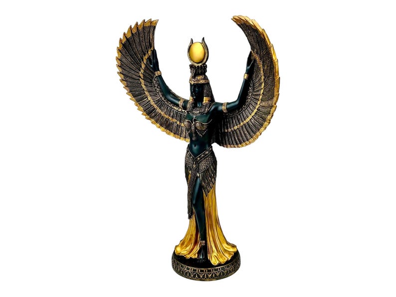 May include: A black and gold statue of the Egyptian goddess Isis with outstretched wings. She is wearing a golden crown and a flowing robe.