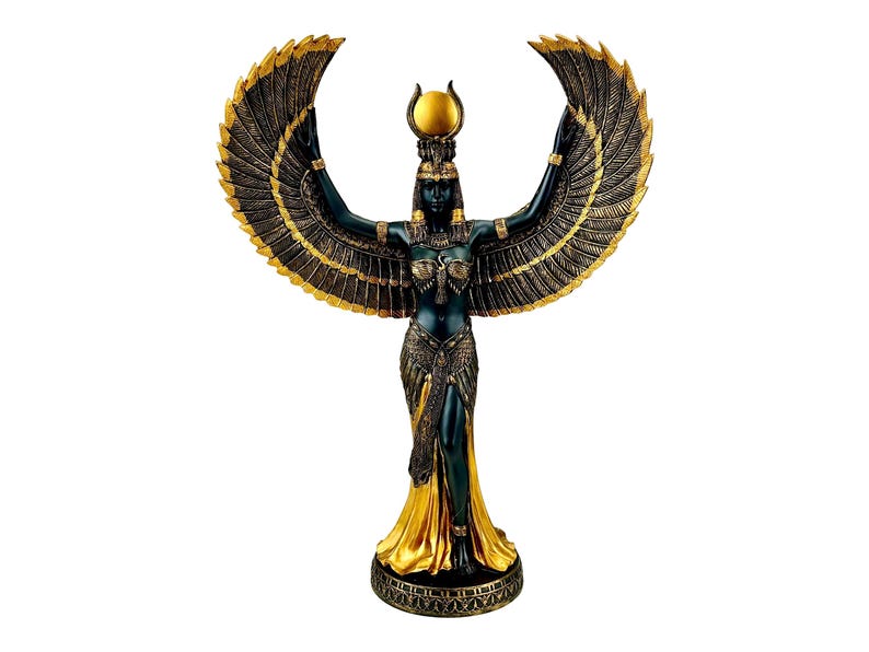 May include: A black and gold statue of the Egyptian goddess Isis with outstretched wings. She is wearing a golden crown and a flowing robe.