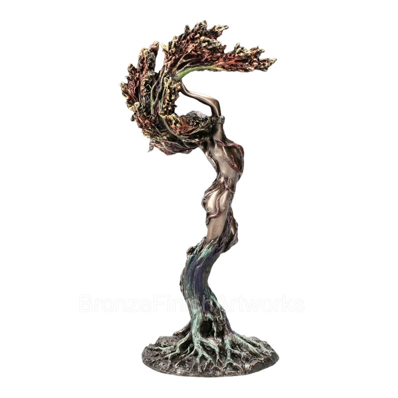 May include: A bronze-toned sculpture depicting a figure merging with a tree, featuring roots at the base, a trunk-like torso, and branches extending upward into a canopy of textured, multi-colored leaves in shades of red, gold, and green.