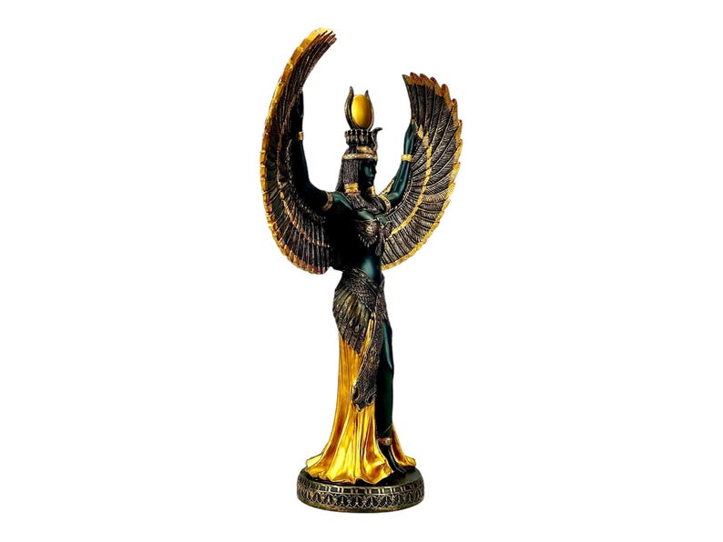May include: A gold and black statue of the Egyptian goddess Isis with outstretched wings. She is wearing a golden crown and a flowing robe.