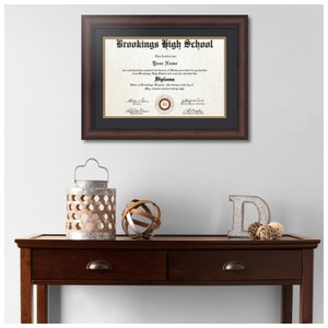 May include: A framed diploma from Brookings High School with the text "This Certifies that...has satisfactorily completed the Course of Study prescribed for graduation from Brookings High School and is hereby entitled to this Diploma."