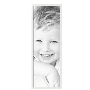 May include: Black and white portrait of a smiling child with light-colored hair, framed in a white rectangular border. The child is looking directly at the viewer, with a wide, genuine smile.