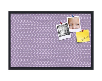 May include: A purple cork board with a black frame. The cork board has a white geometric pattern. There are two photos pinned to the board, one of a young girl and one of a young boy. A yellow sticky note with the text "Thank you!" is also pinned to the board.