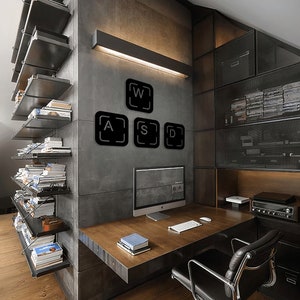 May include: A modern home office with a desk, a computer, and a chair. The wall behind the desk is decorated with black metal keyboard keys that spell out "WASD".