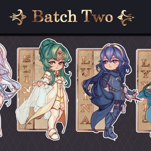 Peut inclure: Quatre personnages illustrés de la série Fire Emblem. Les personnages sont dans un style chibi et se tiennent devant un fond doré avec le texte "Batch Two". Les personnages sont : un personnage féminin aux longs cheveux blancs et une robe blanche, un personnage féminin aux longs cheveux verts et une robe blanche, un personnage féminin aux longs cheveux bleus et une robe bleue, et un personnage féminin aux longs cheveux verts et une robe bleue.