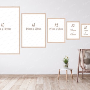 May include: A white wall with six different sized picture frames, each with a different size label. The frames are labeled A0, A1, A2, A3, A4, and A5. The frames are all made of wood and have a light brown finish. The frames are all empty and have a white background. The frames are all hanging on the wall. The wall is painted white. The frames are all in a row, with the largest frame on the left and the smallest frame on the right. The frames are all evenly spaced apart. The frames are all in focus. The wall is in focus. The background is blurred.