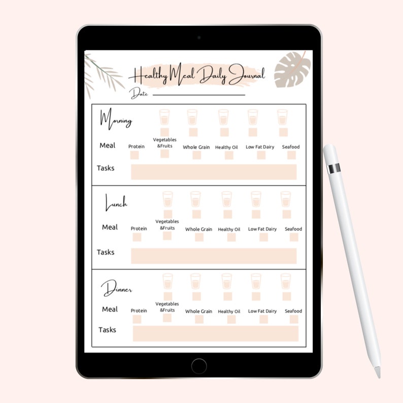 May include: A black tablet displays a "Healthy Meal Daily Journal" layout with sections for morning, lunch, and dinner. Each section includes meal categories like protein, vegetables, and seafood. A white stylus rests on the right side.