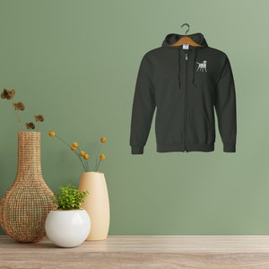 May include: A black zippered hoodie with a white dalmatian dog graphic on the left chest.