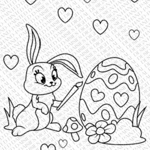 May include: A black and white line drawing of a bunny rabbit holding a paintbrush and painting an Easter egg. The egg is decorated with hearts. The bunny is sitting next to a mushroom and a flower.